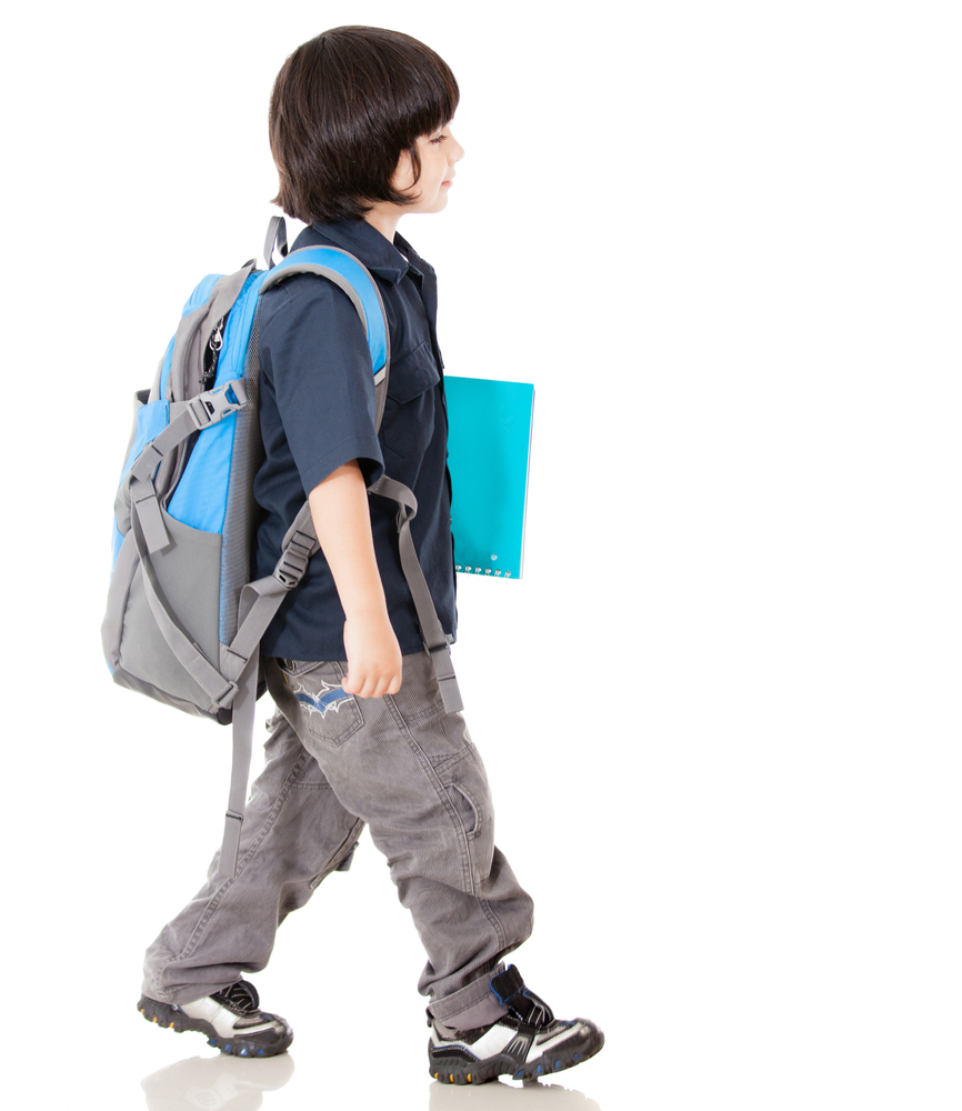 Boy walking to school - isolated over a white background