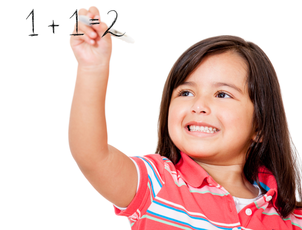 School girl learning to add and writing on the board - isolaed