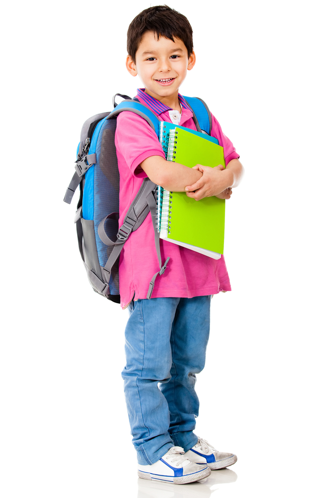 Young preschool student carrying backpack and notebooks - isolated over white